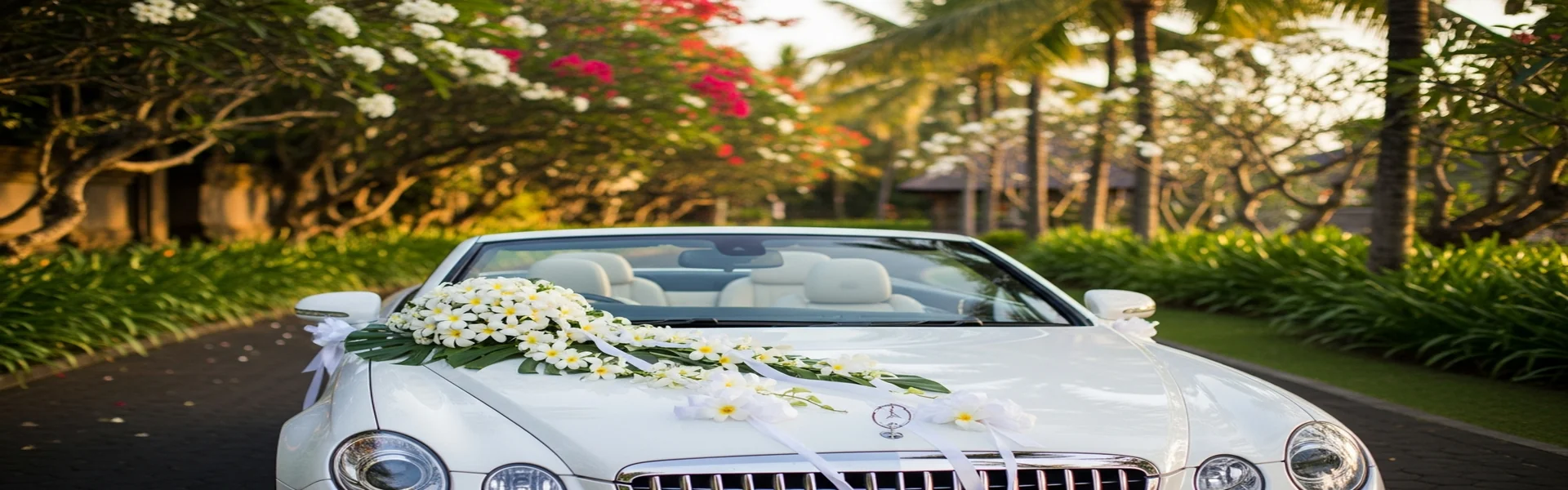 Wedding car rental Bali - decorated luxury convertible in tropical garden